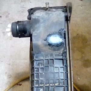 Case 580 Super L radiator repair using a plastic weld, fiberglass patch and epoxy coating.